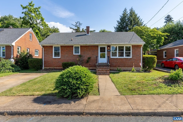 1211 River Vista Ave, Charlottesville, VA 22901 - view of front of home with brick siding, a front yard, a chimney, and roof with shingles