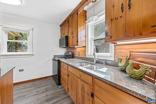 1211 River Vista Ave, Charlottesville, VA 22901 - kitchen featuring stainless steel range with electric cooktop, black microwave, wood finished floors, and dark stone countertops