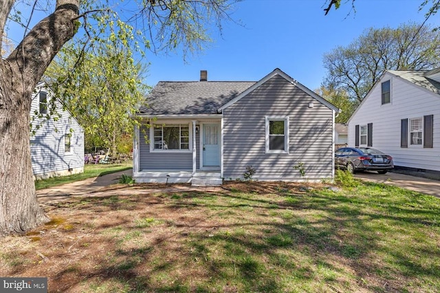 view of front of house featuring a front lawn and a chimney