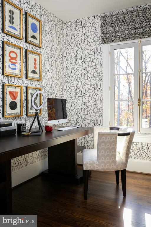  - office space featuring wallpapered walls, wood finished floors, and built in study area