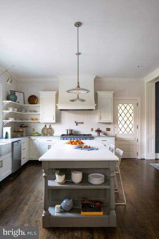  - kitchen featuring open shelves, light countertops, white cabinetry, crown molding, and stainless steel dishwasher