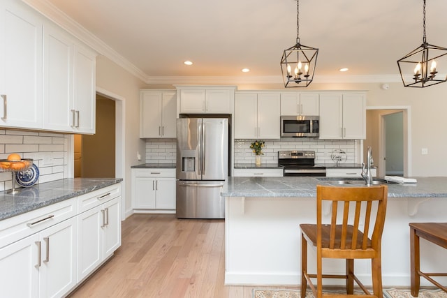 33 Silver Maple Cv, Fishersville, VA 22939 - kitchen featuring appliances with stainless steel finishes, a sink, a chandelier, backsplash, and ornamental molding