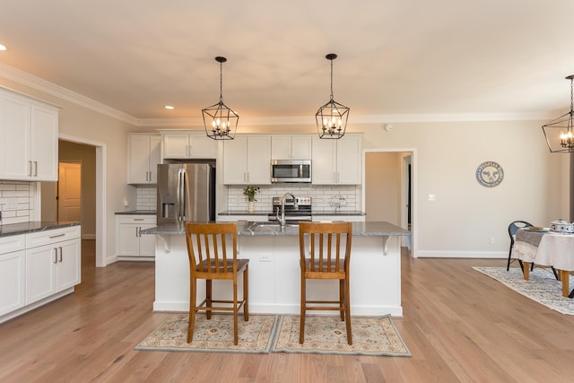 33 Silver Maple Cv, Fishersville, VA 22939 - kitchen with appliances with stainless steel finishes, backsplash, a chandelier, crown molding, and a breakfast bar area