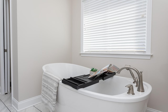 33 Silver Maple Cv, Fishersville, VA 22939 - bathroom featuring a freestanding tub and baseboards