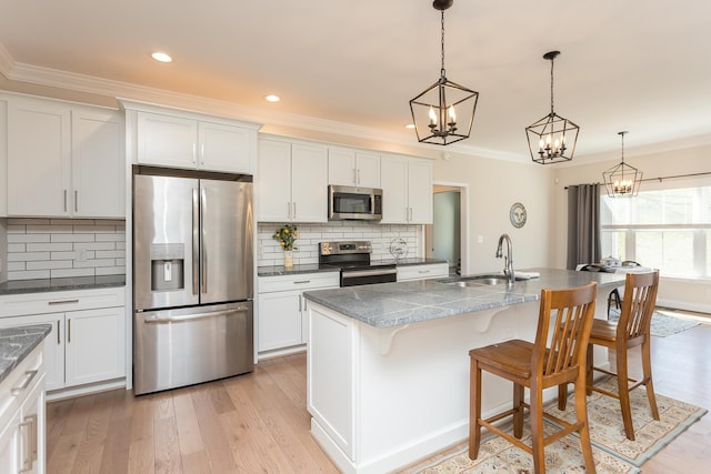 33 Silver Maple Cv, Fishersville, VA 22939 - kitchen featuring appliances with stainless steel finishes, a sink, ornamental molding, a chandelier, and tasteful backsplash