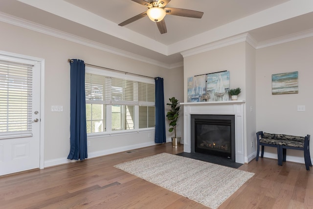 33 Silver Maple Cv, Fishersville, VA 22939 - living room featuring a fireplace with flush hearth, ceiling fan, wood finished floors, baseboards, and crown molding