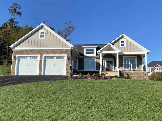 33 Silver Maple Cv, Fishersville, VA 22939 - craftsman-style house featuring driveway, board and batten siding, a garage, a front yard, and covered porch