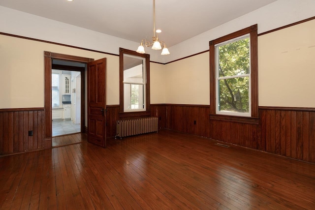 557 Wayne Ave S, Waynesboro, VA 22980 - empty room with radiator, wainscoting, hardwood / wood-style floors, a chandelier, and plenty of natural light