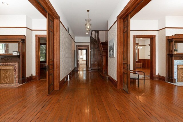 557 Wayne Ave S, Waynesboro, VA 22980 - corridor featuring wood-type flooring, baseboards, radiator heating unit, and wallpapered walls