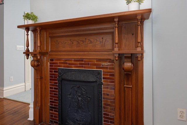 557 Wayne Ave S, Waynesboro, VA 22980 - detailed view of a tile fireplace, wood finished floors, and baseboards