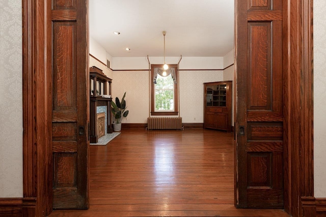 557 Wayne Ave S, Waynesboro, VA 22980 - corridor featuring radiator heating unit, hardwood / wood-style floors, and baseboards