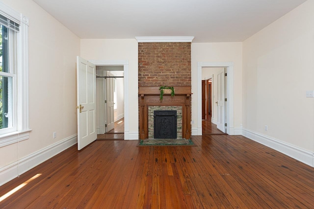 557 Wayne Ave S, Waynesboro, VA 22980 - unfurnished living room featuring healthy amount of natural light, a brick fireplace, and hardwood / wood-style flooring