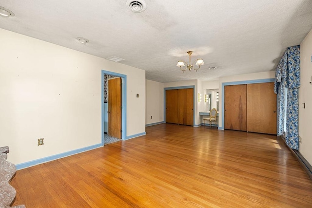 188 Middlebrook Rd, Staunton, VA 24401 - unfurnished bedroom featuring a chandelier, light wood-style flooring, and baseboards