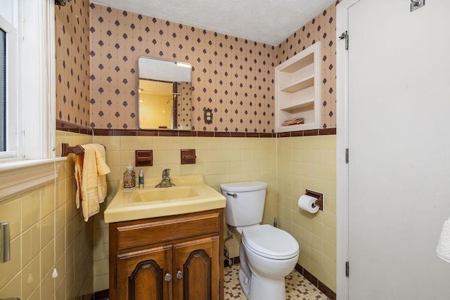 188 Middlebrook Rd, Staunton, VA 24401 - bathroom with wallpapered walls, tile walls, vanity, a wainscoted wall, and toilet