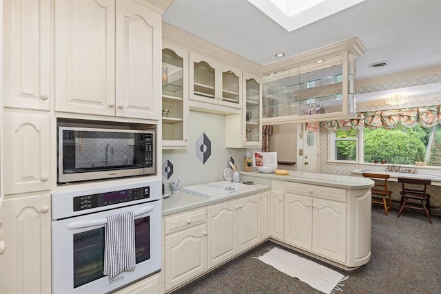 188 Middlebrook Rd, Staunton, VA 24401 - kitchen featuring white appliances, a peninsula, glass insert cabinets, dark carpet, and light countertops