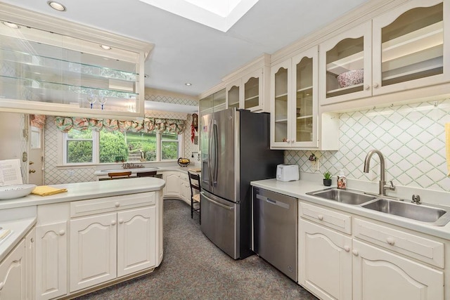 188 Middlebrook Rd, Staunton, VA 24401 - kitchen featuring appliances with stainless steel finishes, a sink, tasteful backsplash, glass insert cabinets, and light countertops