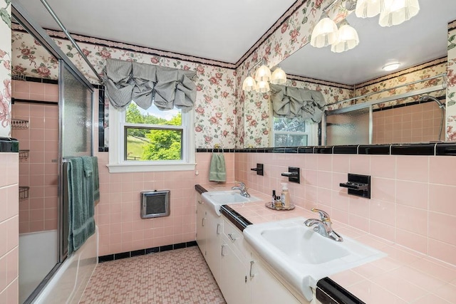 188 Middlebrook Rd, Staunton, VA 24401 - full bath featuring wallpapered walls, tile walls, double vanity, enclosed tub / shower combo, and a wainscoted wall