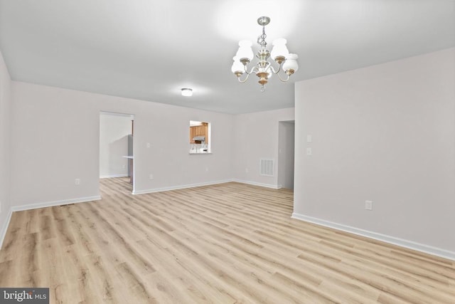 447 Laurel Ave, Fredericksburg, VA 22408 - unfurnished living room with a chandelier, light wood-style floors, and baseboards