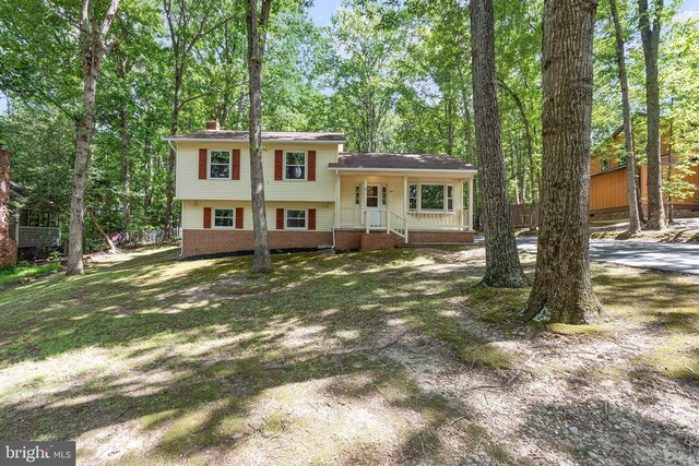 447 Laurel Ave, Fredericksburg, VA 22408 - split level home featuring a chimney and a porch