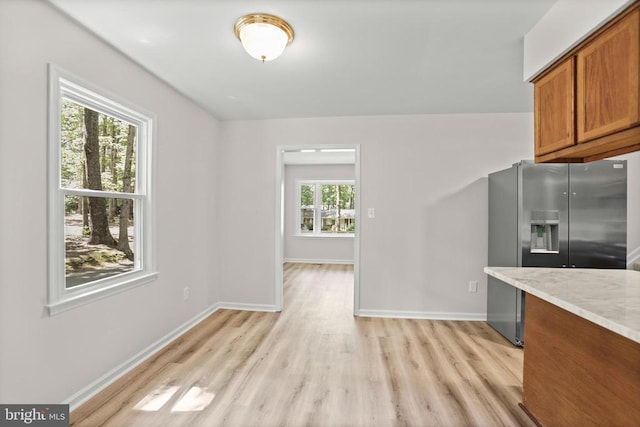 447 Laurel Ave, Fredericksburg, VA 22408 - kitchen featuring stainless steel refrigerator with ice dispenser, brown cabinets, light wood-style floors, and baseboards