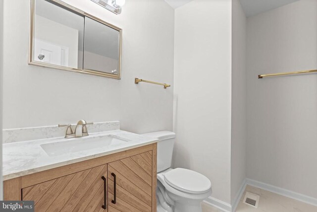 447 Laurel Ave, Fredericksburg, VA 22408 - bathroom with toilet, vanity, baseboards, and marble look tiles