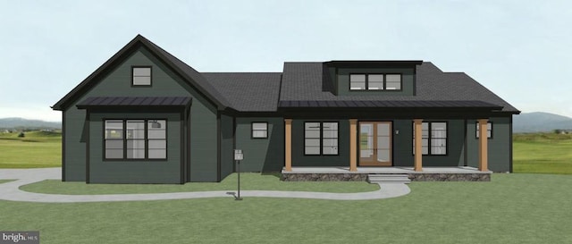 view of front of house with a porch, a standing seam roof, a front lawn, and metal roof