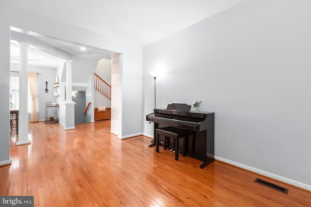 5502 Joshua Tree Cir, Fredericksburg, VA 22407 - sitting room featuring decorative columns, hardwood / wood-style flooring, stairway, and baseboards