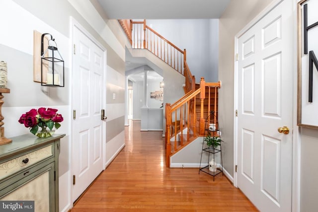 5502 Joshua Tree Cir, Fredericksburg, VA 22407 - foyer featuring light wood-style floors, stairs, decorative columns, and baseboards