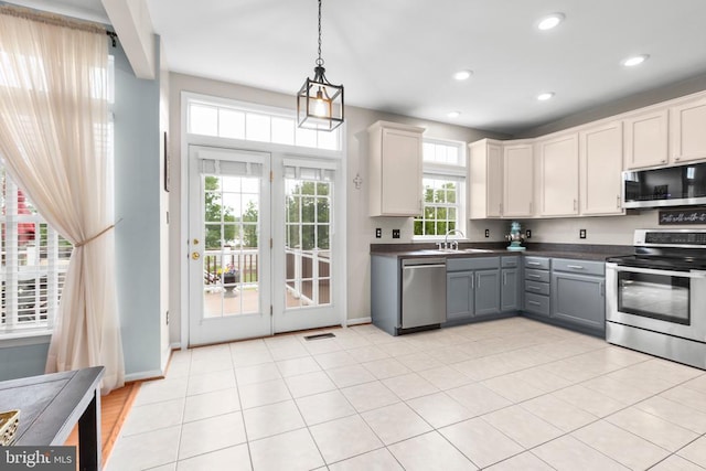 5502 Joshua Tree Cir, Fredericksburg, VA 22407 - kitchen with a sink, stainless steel appliances, pendant lighting, gray cabinetry, and dark countertops