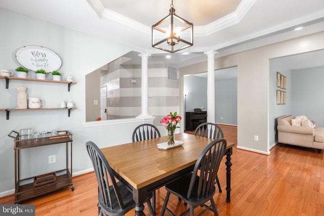 5502 Joshua Tree Cir, Fredericksburg, VA 22407 - dining room featuring a tray ceiling, light wood-style flooring, visible vents, and decorative columns