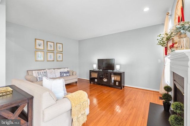5502 Joshua Tree Cir, Fredericksburg, VA 22407 - living area featuring light wood finished floors, baseboards, recessed lighting, and a fireplace with flush hearth