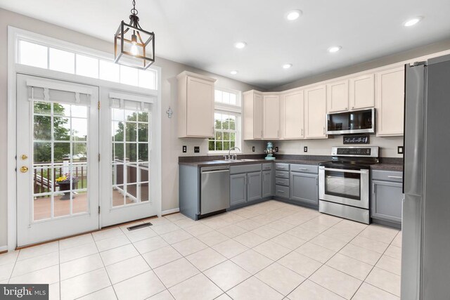 5502 Joshua Tree Cir, Fredericksburg, VA 22407 - kitchen featuring appliances with stainless steel finishes, dark countertops, gray cabinets, hanging light fixtures, and recessed lighting