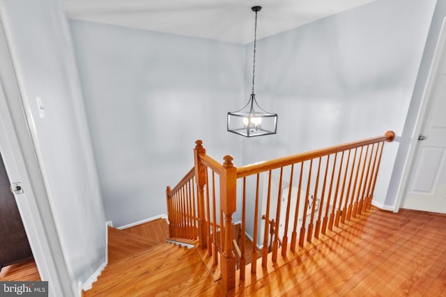 5502 Joshua Tree Cir, Fredericksburg, VA 22407 - staircase featuring baseboards, a notable chandelier, and wood finished floors