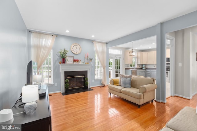 5502 Joshua Tree Cir, Fredericksburg, VA 22407 - living room with light wood finished floors, plenty of natural light, a fireplace with flush hearth, recessed lighting, and baseboards