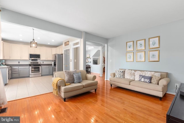 5502 Joshua Tree Cir, Fredericksburg, VA 22407 - living room with light wood-style floors, recessed lighting, and ornate columns