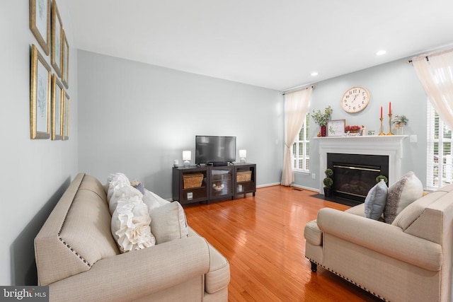 5502 Joshua Tree Cir, Fredericksburg, VA 22407 - living area with wood finished floors, a fireplace with flush hearth, and recessed lighting