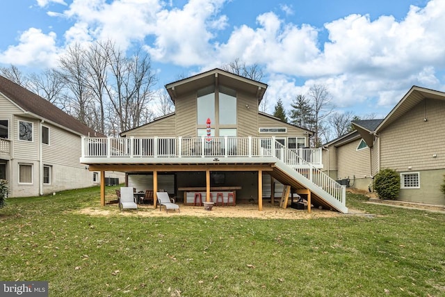 back of property featuring stairway, a yard, and a deck