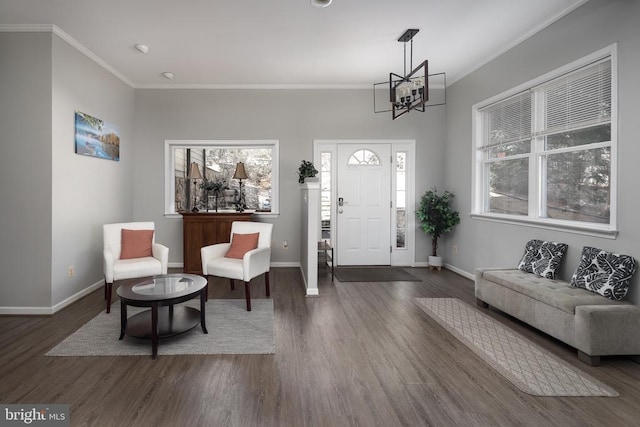 entryway featuring a chandelier, baseboards, plenty of natural light, and crown molding