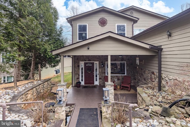 view of front of home featuring a porch and stone siding