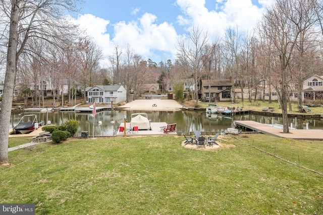 dock with a residential view, a water view, and a lawn