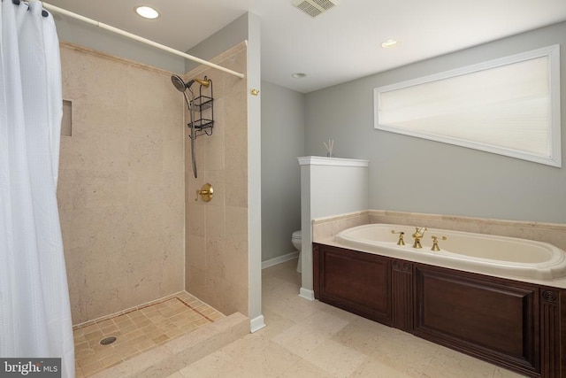 bathroom featuring a bath, a shower stall, baseboards, toilet, and recessed lighting