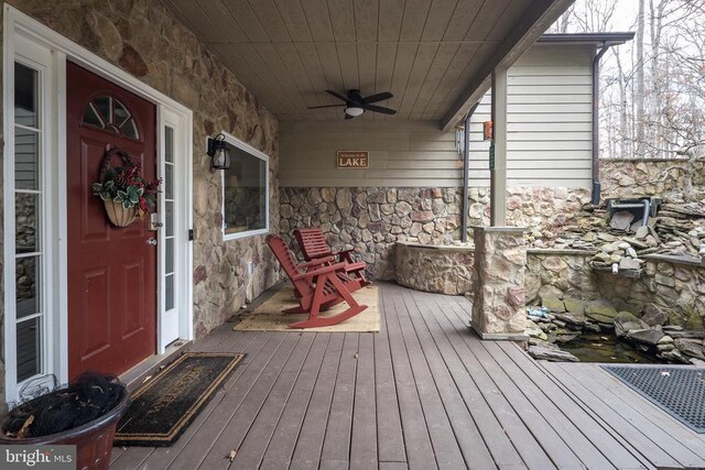 deck with a porch and a ceiling fan