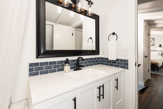 16184 Moonrise Ln, Broadway, VA 22815 - bathroom with vanity, decorative backsplash, wood finished floors, and connected bathroom