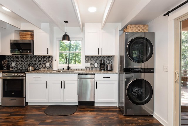 16184 Moonrise Ln, Broadway, VA 22815 - kitchen with estacked washer and dryer, stainless steel appliances, light stone countertops, dark wood finished floors, and backsplash