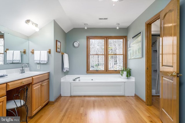 695 Whippoorwill Ln, Shipman, VA 22971 - full bath with plenty of natural light, wood finished floors, a bath, vanity, and vaulted ceiling