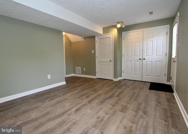 9600 Becker Ct, Fredericksburg, VA 22408 - basement with baseboards, visible vents, a textured ceiling, and wood finished floors