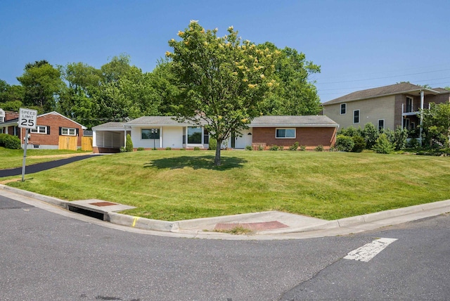 100 Monument Ave, Harrisonburg, VA 22801 - ranch-style house featuring a front lawn, brick siding, and a detached carport