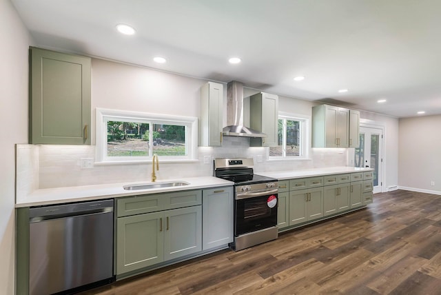 100 Monument Ave, Harrisonburg, VA 22801 - kitchen featuring stainless steel appliances, a sink, wall chimney exhaust hood, green cabinetry, and light countertops