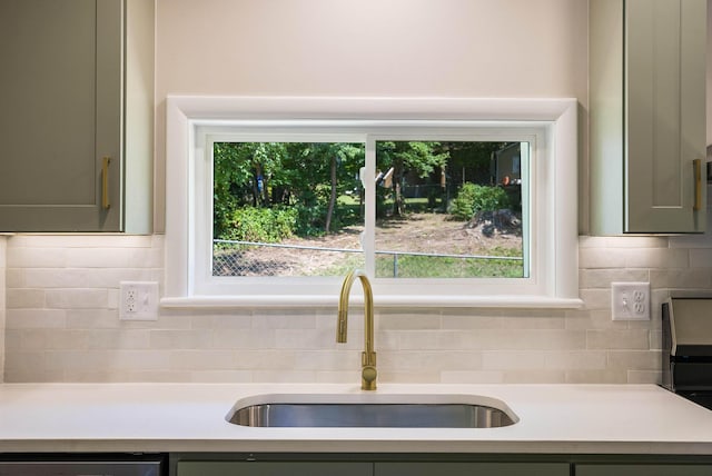100 Monument Ave, Harrisonburg, VA 22801 - kitchen featuring light countertops, a sink, decorative backsplash, and dishwasher
