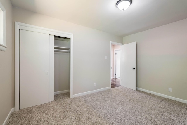 100 Monument Ave, Harrisonburg, VA 22801 - unfurnished bedroom featuring carpet floors, a closet, and baseboards